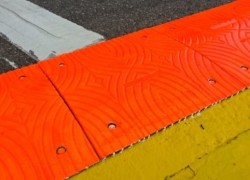 FIA orange sausage kerb removed at top of Eau Rouge